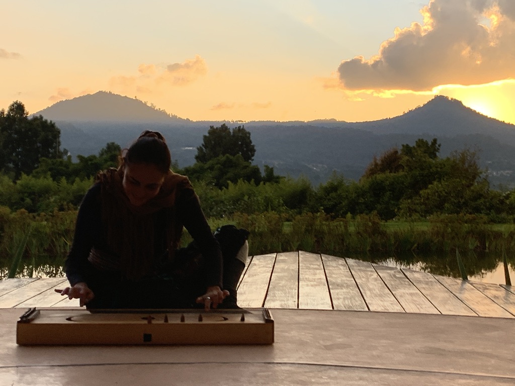 Sound healing on the lakeside deck at sunset